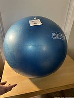 Photo of a large blue exercise ball showing its size and condition with visible Plus logo.