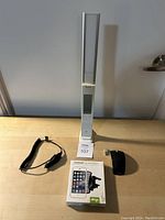 LED light standing on table with car charger, USB adapter, and boxed universal car yeet magnetic phone mount