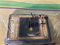 Stack of Yu-Gi-Oh trading cards in a sealed transparent plastic bag labeled with number 100+