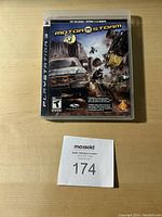 Front of MotorStorm video game case for PS3 showing cover art and ratings, tagged with auction number 174.