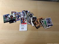 A collection of assorted sports cards laid out on a table showing various players from multiple sports.