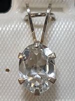 Close-up front view of the oval faceted aquamarine gemstone set in sterling silver pendant.