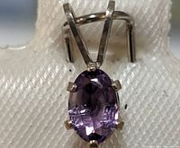 Close-up of front view of the oval amethyst pendant in sterling silver showing the gemstone and prong setting.