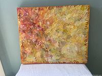 Full view of the rectangular Sunspot fabric collage artwork showing bright yellow and orange tones and textured quilting pattern.