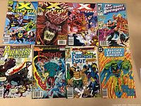 Photo showing eight comic books neatly arranged in two rows of four on a white surface