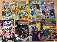 Photo showing 8 comics from Marvel and DC including Justice League, Avengers, Wolverine, Ghost Rider, Iron Fist, Fantastic Four