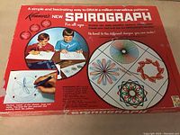 Box cover of vintage Kenner Spirograph game showing children using the set and examples of drawn patterns