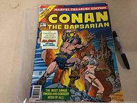 Front cover of the 1977 Conan the Barbarian Marvel Treasury Edition comic, showing Conan and a female warrior with swords, some wear and staining on cover edges.