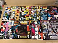 Photo showing all 20 Punisher comics arranged in two rows, displaying varied cover art and mostly high-grade condition.