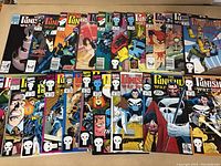 Photo showing 20 Punisher comics laid out side-by-side, front covers visible. Includes various issues with Punisher logo and character imagery.