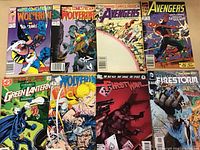 Photo showing 8 comic books spread out, featuring Wolverine, Avengers, Green Lantern, and Firestorm titles.