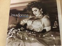 Vinyl LP cover showing Madonna's "Like a Virgin" album artwork with Madonna posing in a lace and polka dot outfit.