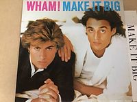 Vinyl album cover for Wham! "Make It Big" with image of the two band members against a white background; colorful album title at top.