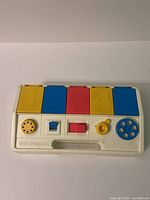 Full view of 1980s Playskool Poppin Pals toy with numbered colored buttons and control features on the front panel.