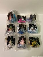 Nine individually bagged Monsters Inc McDonald's toys numbered 1 through 10 (missing #4).