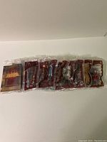 Photo showing all eight Narnia McDonald's toys in original sealed plastic packaging laid out in a row.