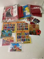 Full lot showing stamps, coins, and flags together on a white surface