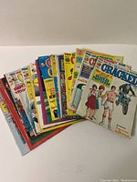 Stack of 20 vintage Cracked magazines showing various front covers with colorful comic illustrations.