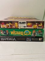 Stacked boxes of three vintage games: Big Loader construction set, The Wizard of Oz, and Mandala.
