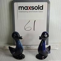 Front view of two blue Blue Mountain Pottery baby duck figurines with ruler showing approximately 5.5 inches tall