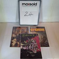 Front view of three comic books standing upright showing full covers: Doctor Zero #1, Adventure Elf Warrior #2, and Warlock #5.