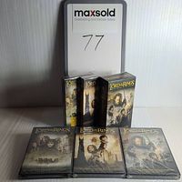 Front view of the sealed and opened Lord of the Rings DVD and VHS sets showing cover art and packaging condition.