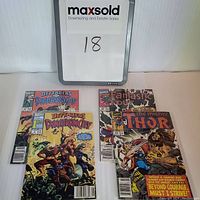 Setup of all 4 comics shown with a whiteboard number 18; includes two Defenders of Dynatron City, Fantastic Four, and The Mighty Thor comics.