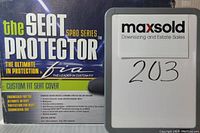 Photo of the front of the seat cover packaging showing the brand, product name, and custom fit design features.