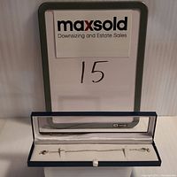 Sterling silver whistle pendant necklace displayed in box with chain extended