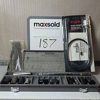 Lot showing unopened Ryobi flex shaft, Maximum metal socket case with sockets, and a sealed pack of 7-inch double-ended Phillips bits.
