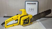 Yellow WEN 14-inch electric chainsaw with detailed view showing saw blade and body.
