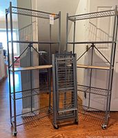 Three shelving units displayed side by side—two taller and one shorter—showing overall lot composition