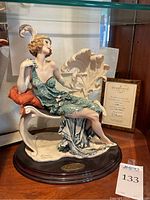 Overall view of sculpture on wood base with certificate in background