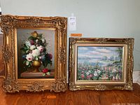 Front view of both paintings side by side showing gilded frames and artwork