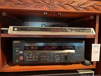 Sony STR-DE445 FM Stereo/AM receiver and Panasonic DVD player placed on wooden furniture.