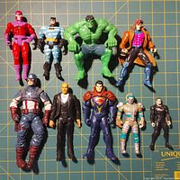 Front side view of 10 Marvel and DC superhero action figures on grid background
