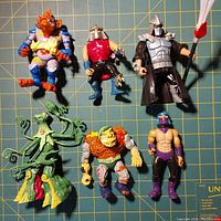 Top view of six TMNT vintage villain action figures showing front detail and condition