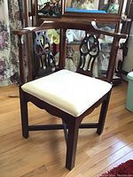 Full view of the vintage solid wood corner chair with upholstered seat, showing carved backrest and cushioned seating.