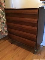 Full view of five-drawer walnut dresser on angled legs