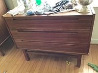 Front view of mid-century modern dresser with items on top