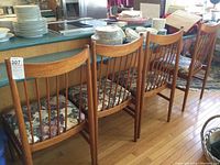 Four chairs in a row next to counter