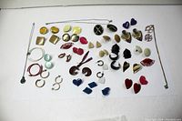 Lot layout showing all earrings and necklaces spread out on white background to show variety and quantity.