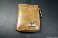 Front view of a brown Alks Kangaroo wallet embossed with kangaroo logo and brand name.