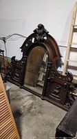 Front view of the large vintage solid wood bar mirror with detailed carvings and central mirror panel