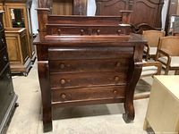 Front view of the dark wood dresser showing full front with four large drawers and two small drawers on top, showing wood grain and drawer knobs.