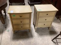 Front view of two light-colored wood nightstands