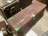Wooden vintage tool box with rope handles shown from front, displaying overall condition and locking hasp.
