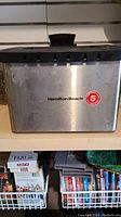 Stainless steel Hamilton Beach deep fryer exterior with a 5-year warranty badge.