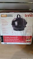 Box of new Bond portable charcoal grill showing front and side images and product details.