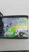 Front view of Slime Smart Repair tire repair kit in transparent carrying case showing package details
